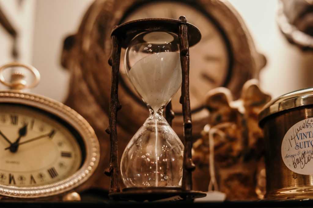 a hourglass and clocks